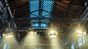 spotlight on the ceiling of a former factory hall for lighting during a concert