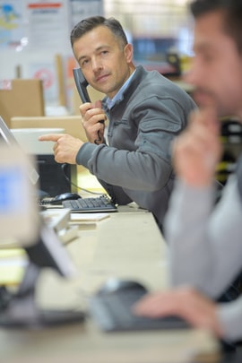 worker in a call center office talking on the phone